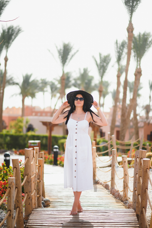 White button-front midi sundress, front view at a tropical resort