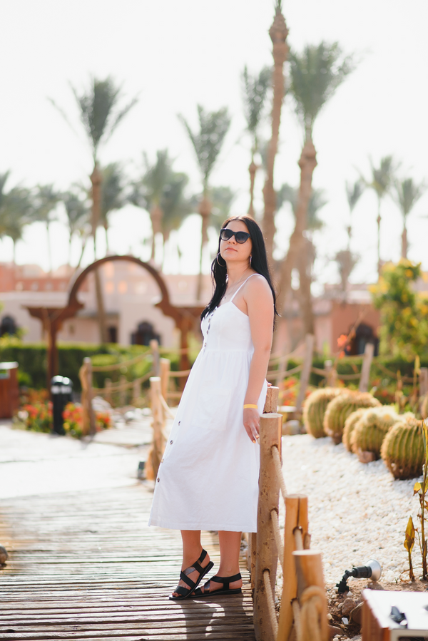 White midi sundress, side view with sunglasses and sandals