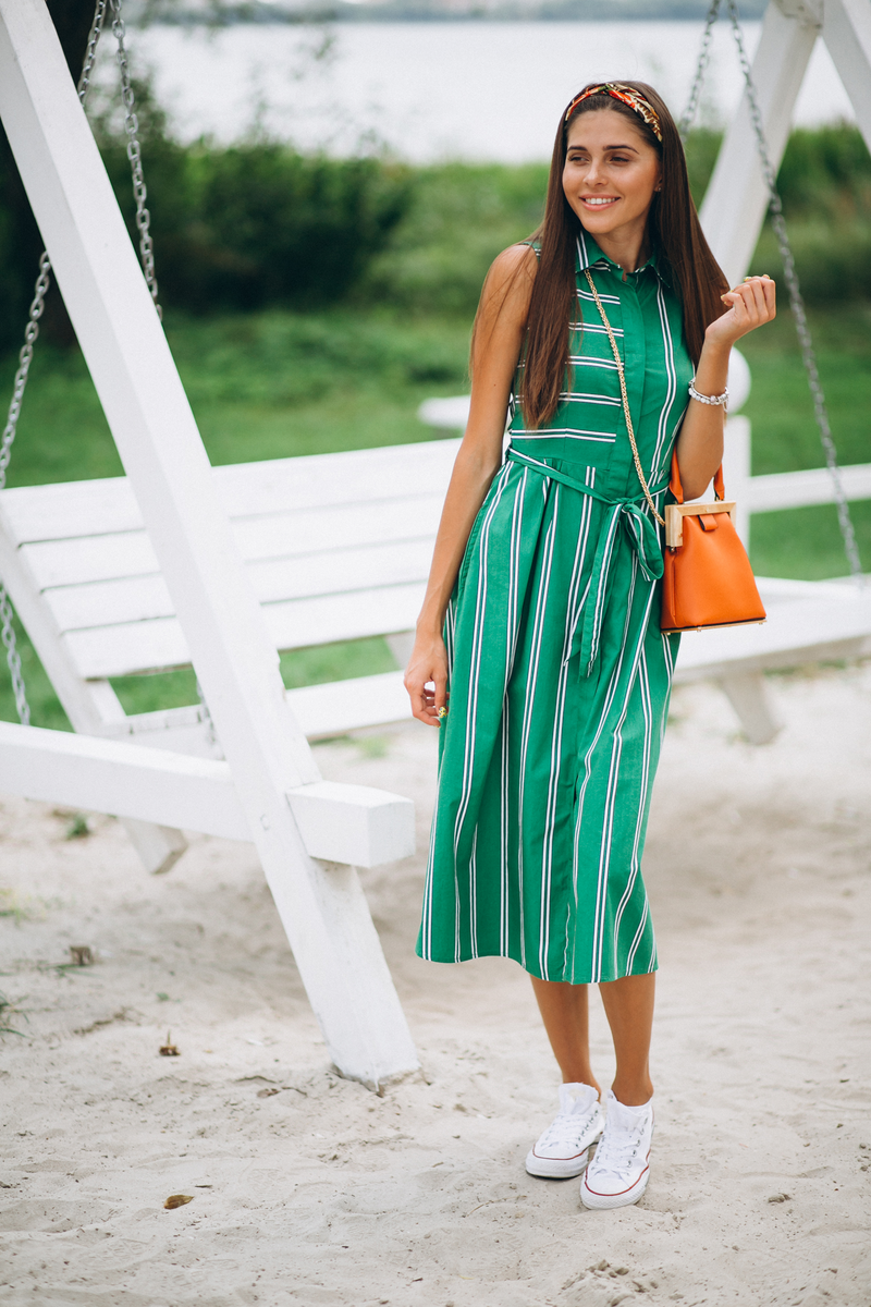Green striped shirt midi dress styled with an orange handbag